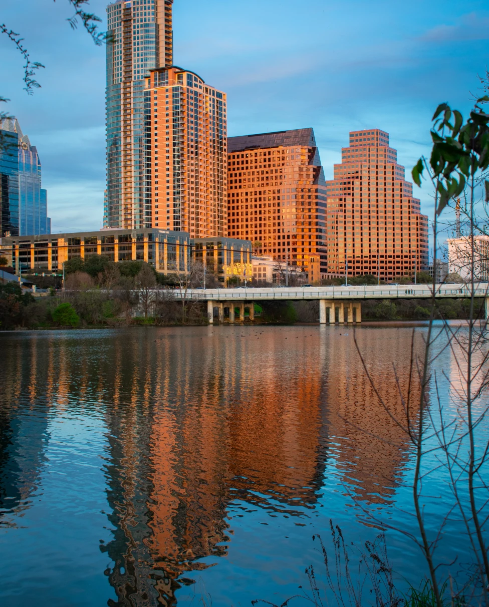A sunset view over the lake of buildings in Austin. 