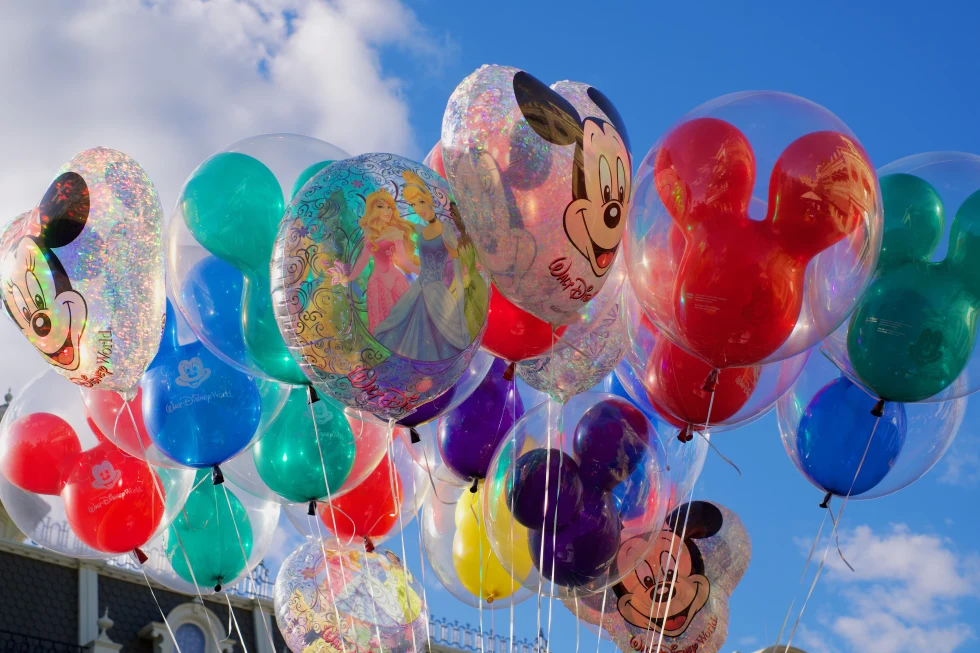 A bunch of Disney balloons against the sky. 