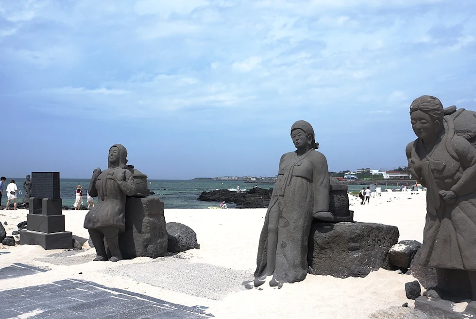 A beach with statues.