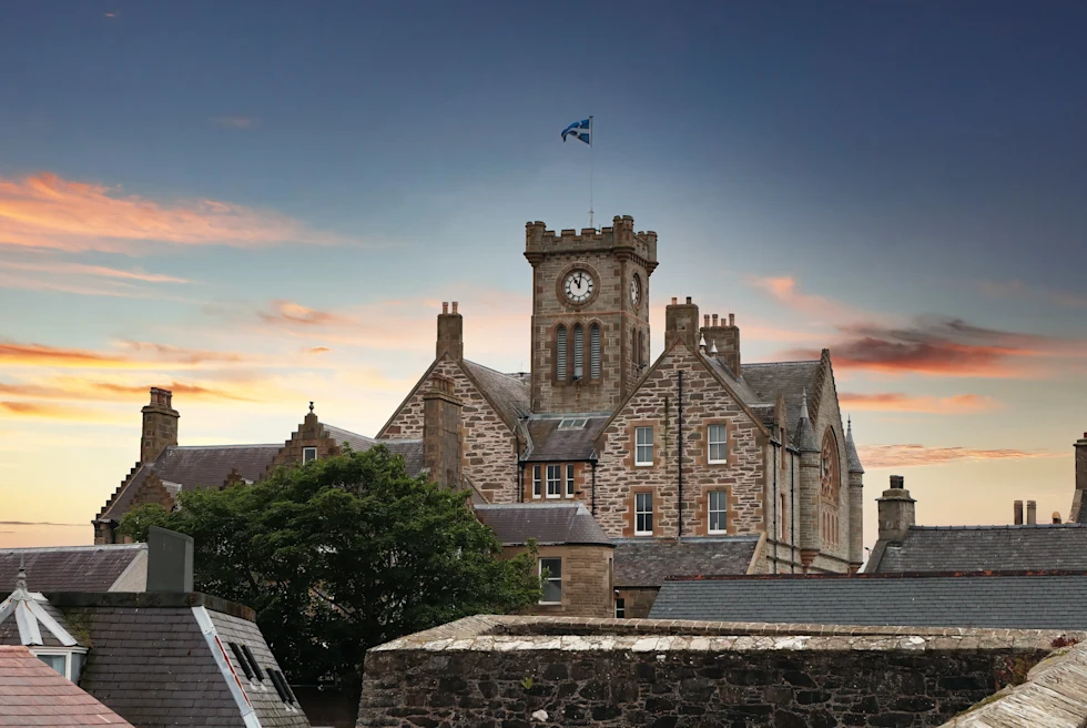 large stone building during sunset