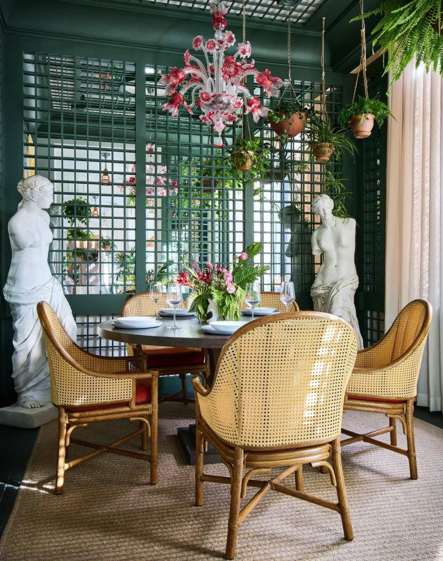 a table in a cozy nook with stone statures of women