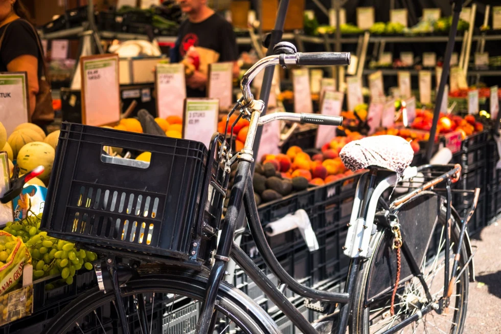 bicycle in front of fruit stand