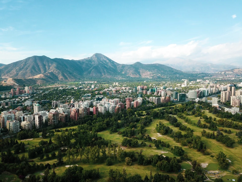 city with green mountains in the background