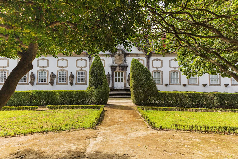 large white building surrounded by trees during daytime