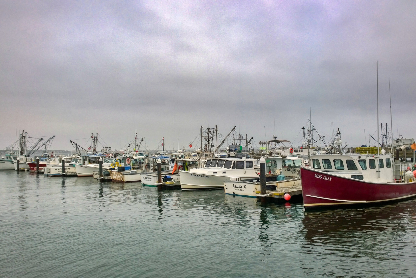 Boats docked in the water on a cloudy day in Provincetown