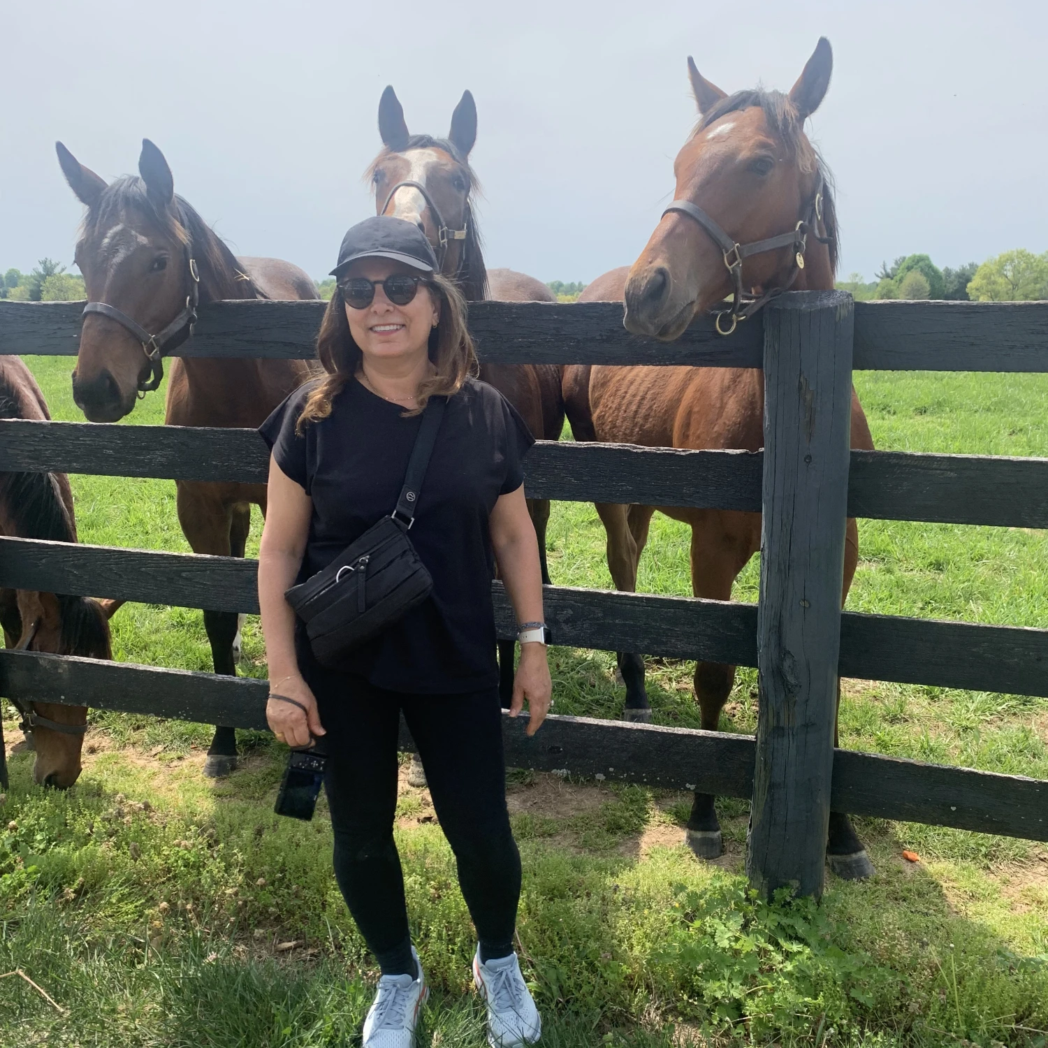 Travel advisor posing with horses
