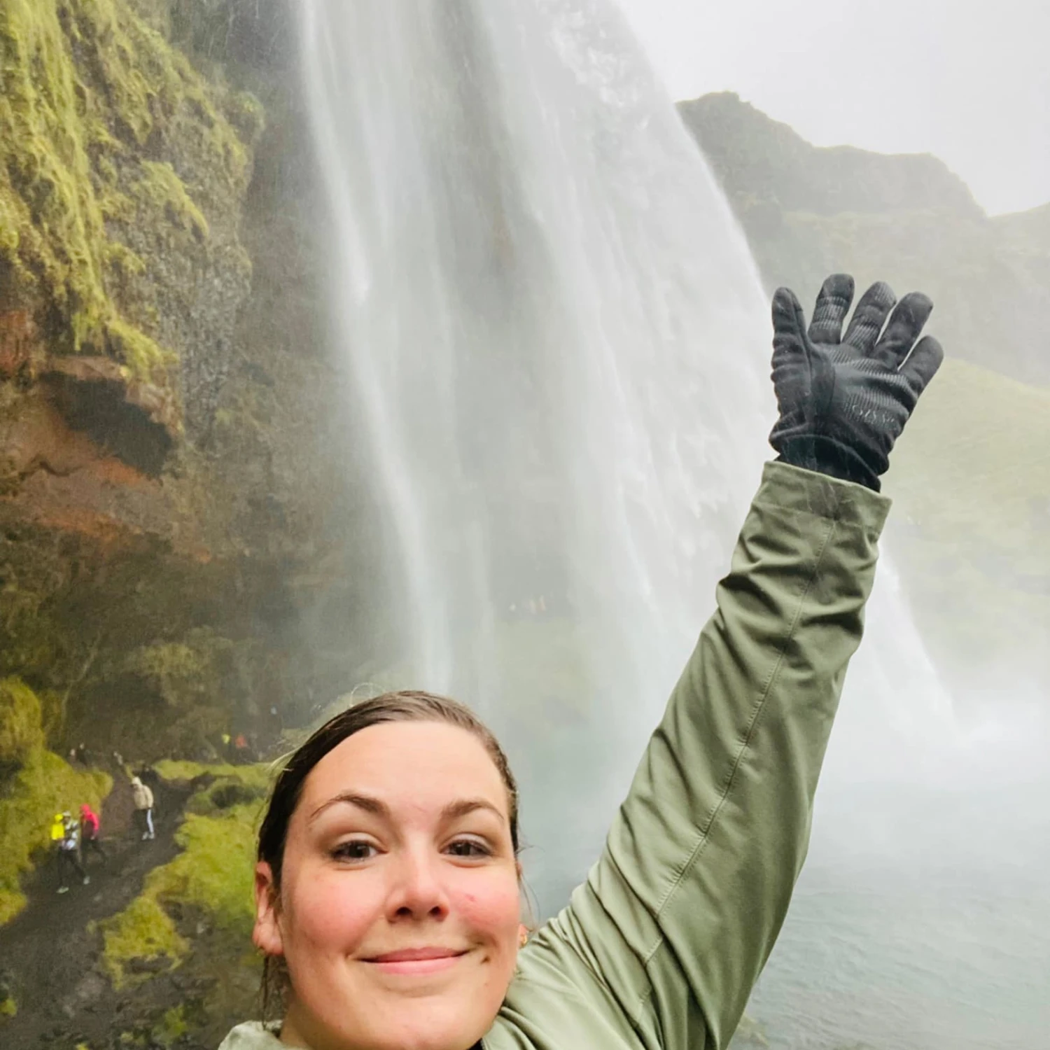 Travel advisor posing in front of a waterfall