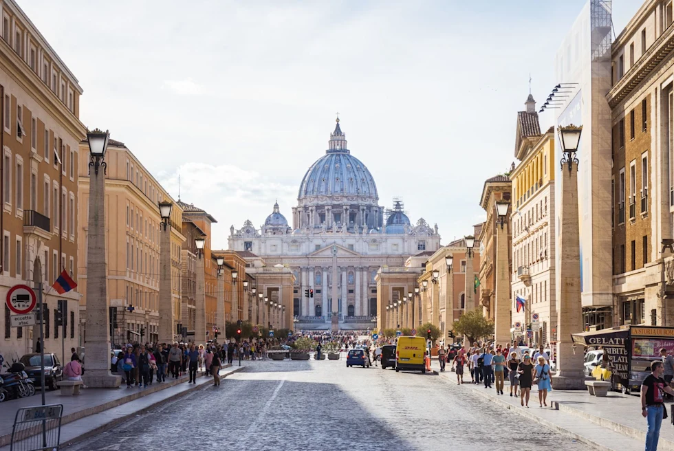 view down a long wide street with building on either side and a landmark at the end