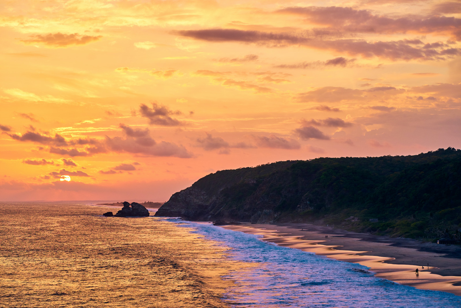 ocean and cliff during sunset