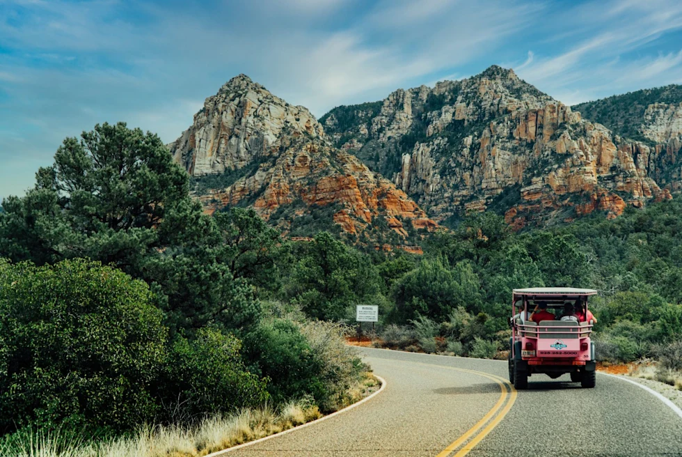 pink jeep through desert mountain road