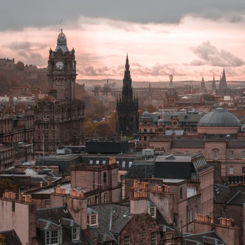 A city view of Edinburgh at sunset.