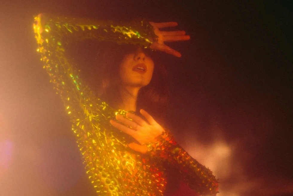 woman in a gold sparkly dress