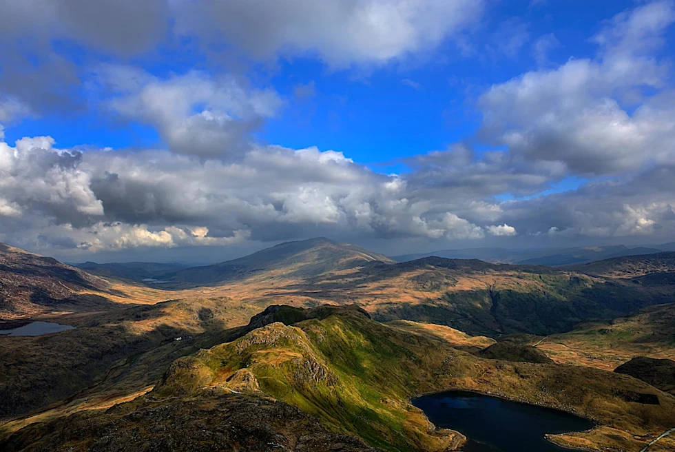 a national park on a sunny day with clouds with many large lakes