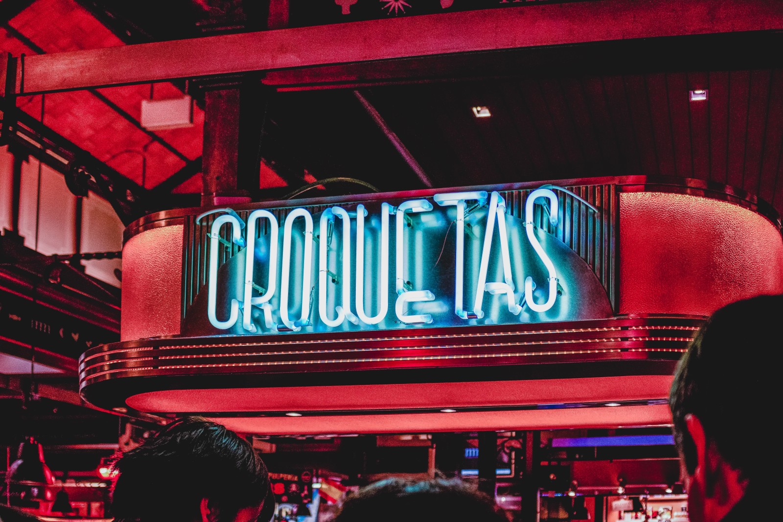 Red neon sign reads "Croquestas" in Madrid, Spain
