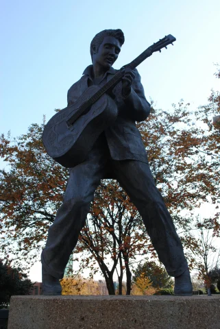 A statue of Elvis playing a guitar