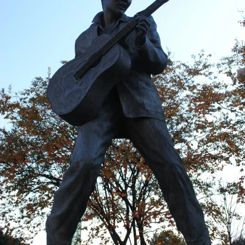 A statue of Elvis playing a guitar