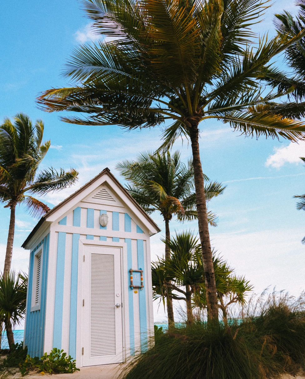 A striped house and palm trees in the Bahamas. 