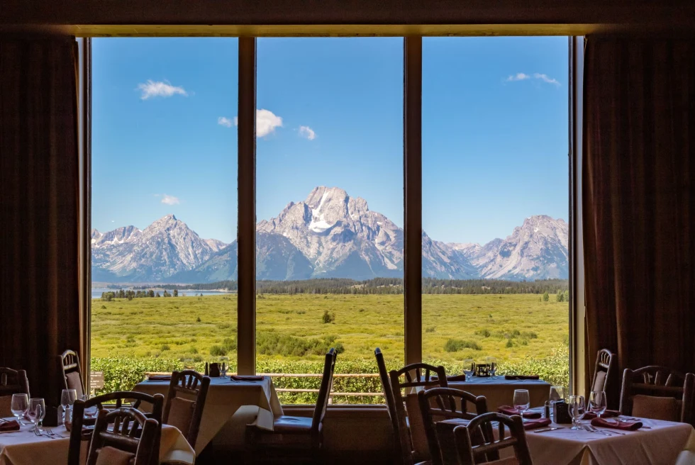 floor to ceiling window looks out to snowy mountain range in fine dining restaurant