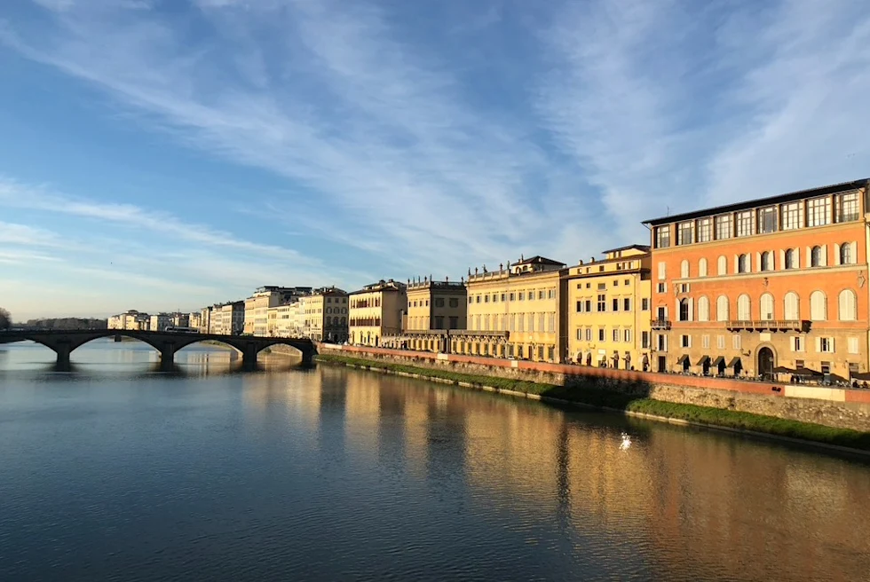 Lake with bridge and buildings.