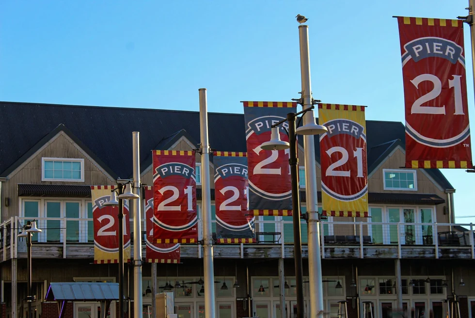 several red signs that read "pier 21"