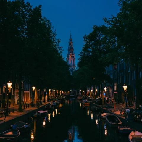 city on a narrow canal lit up at night