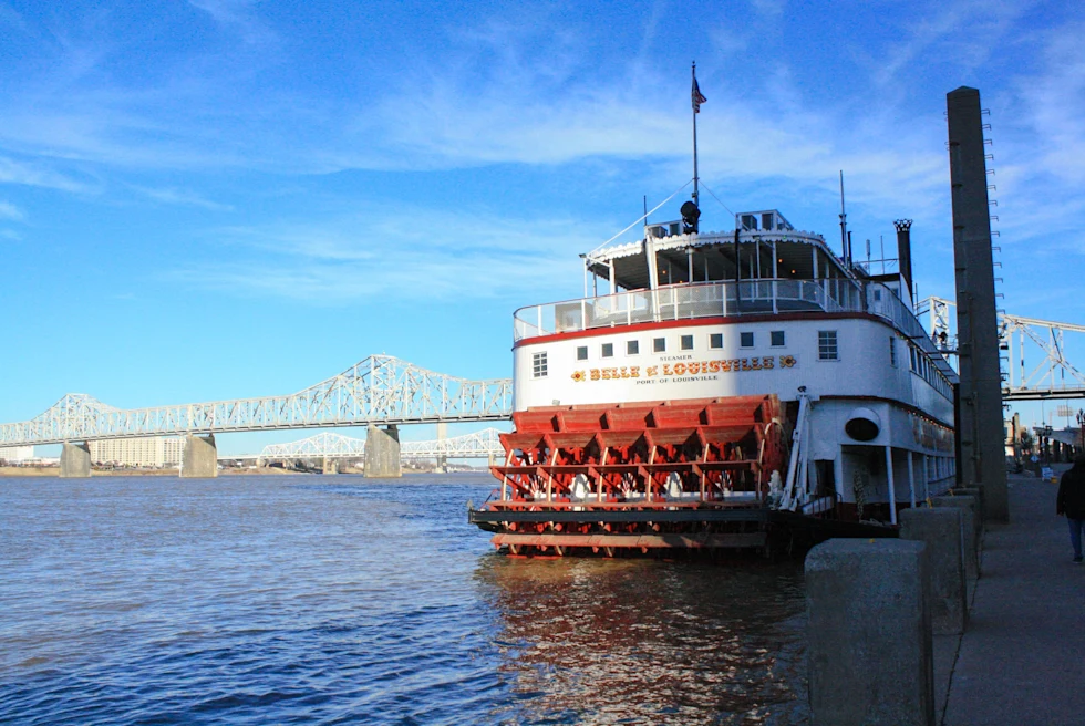 A picture of a river boat anchored to the dock.