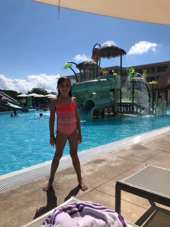 Baby girl posing on the poolside