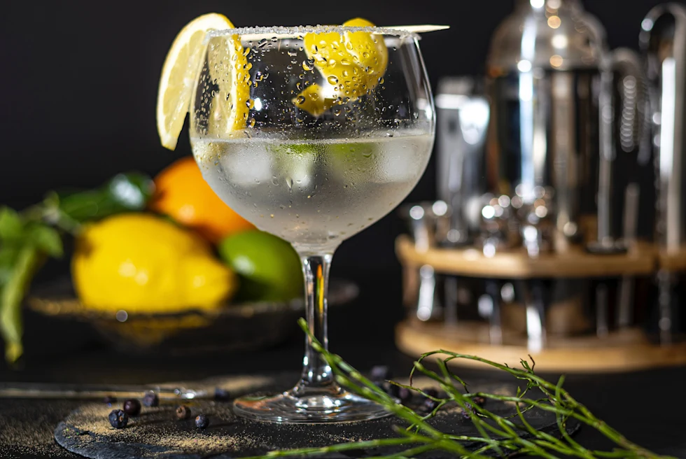 A glass of lime drink with ice outside.