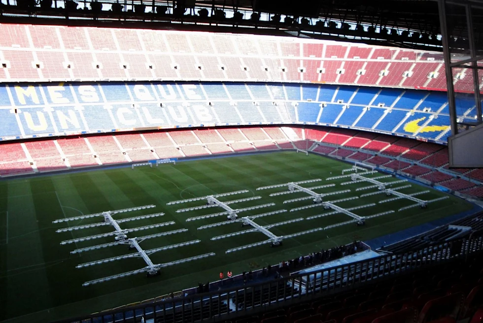 an empty soccer stadium with blue and red seats