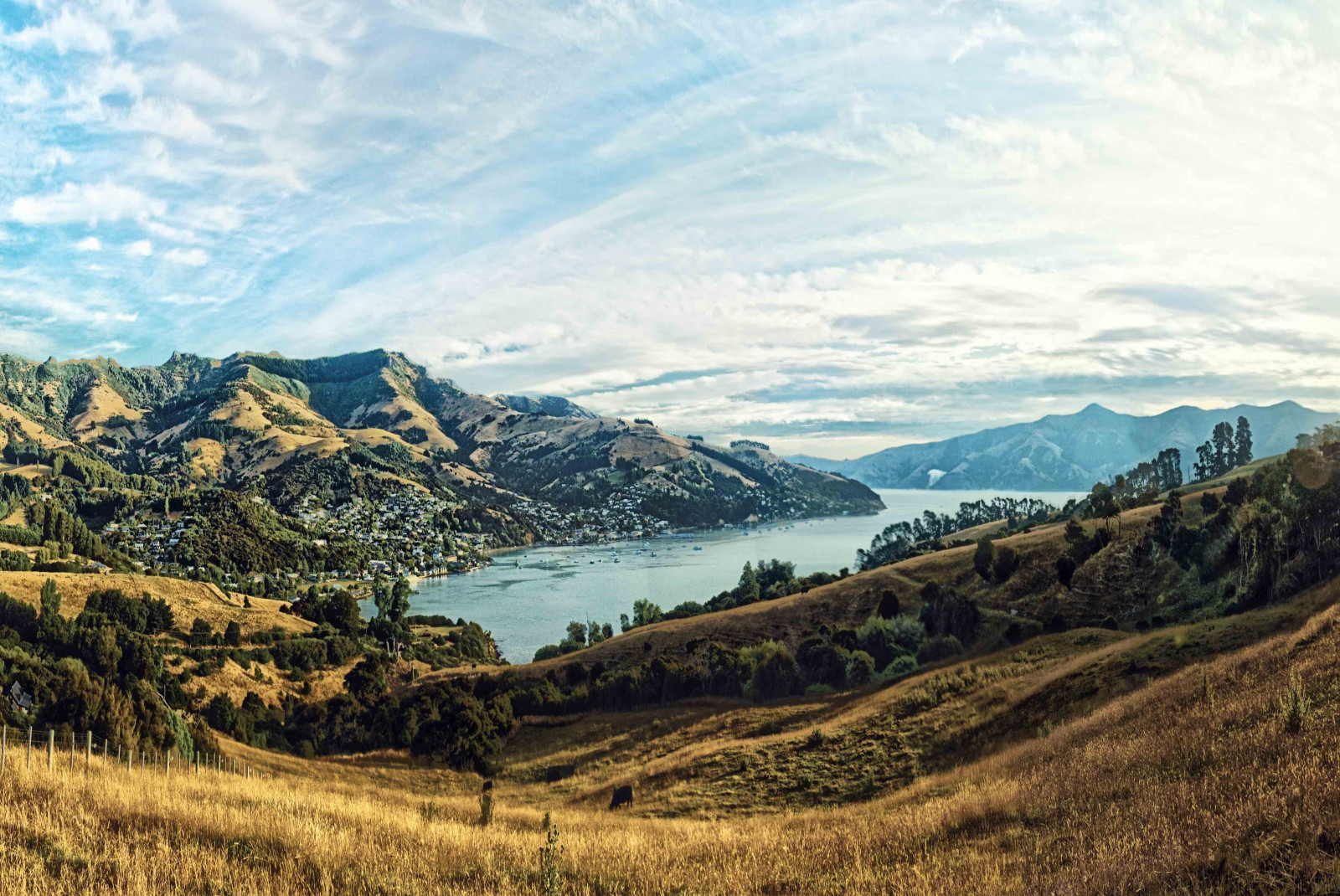 Water and mountains with a blue sky in Akaora, NZ