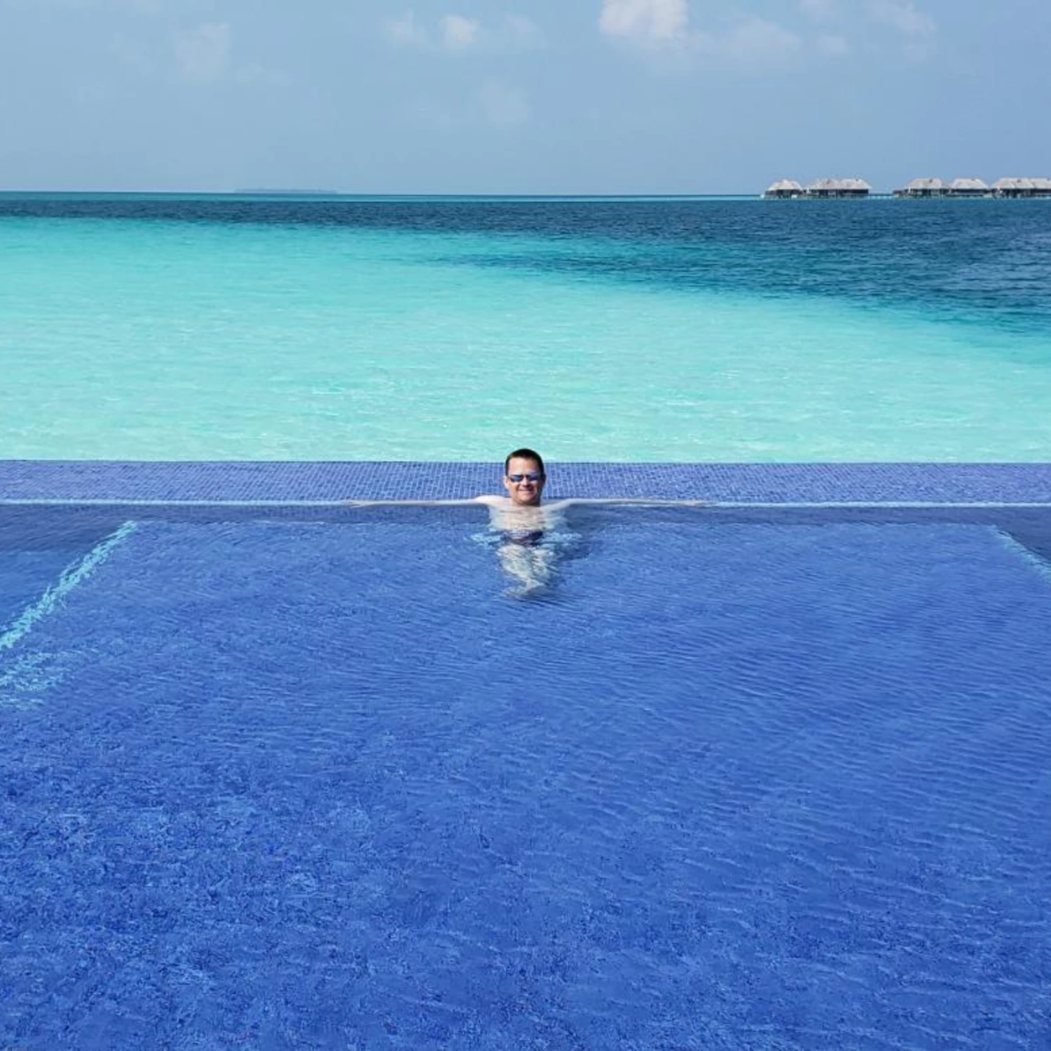 man in pool in the maldives