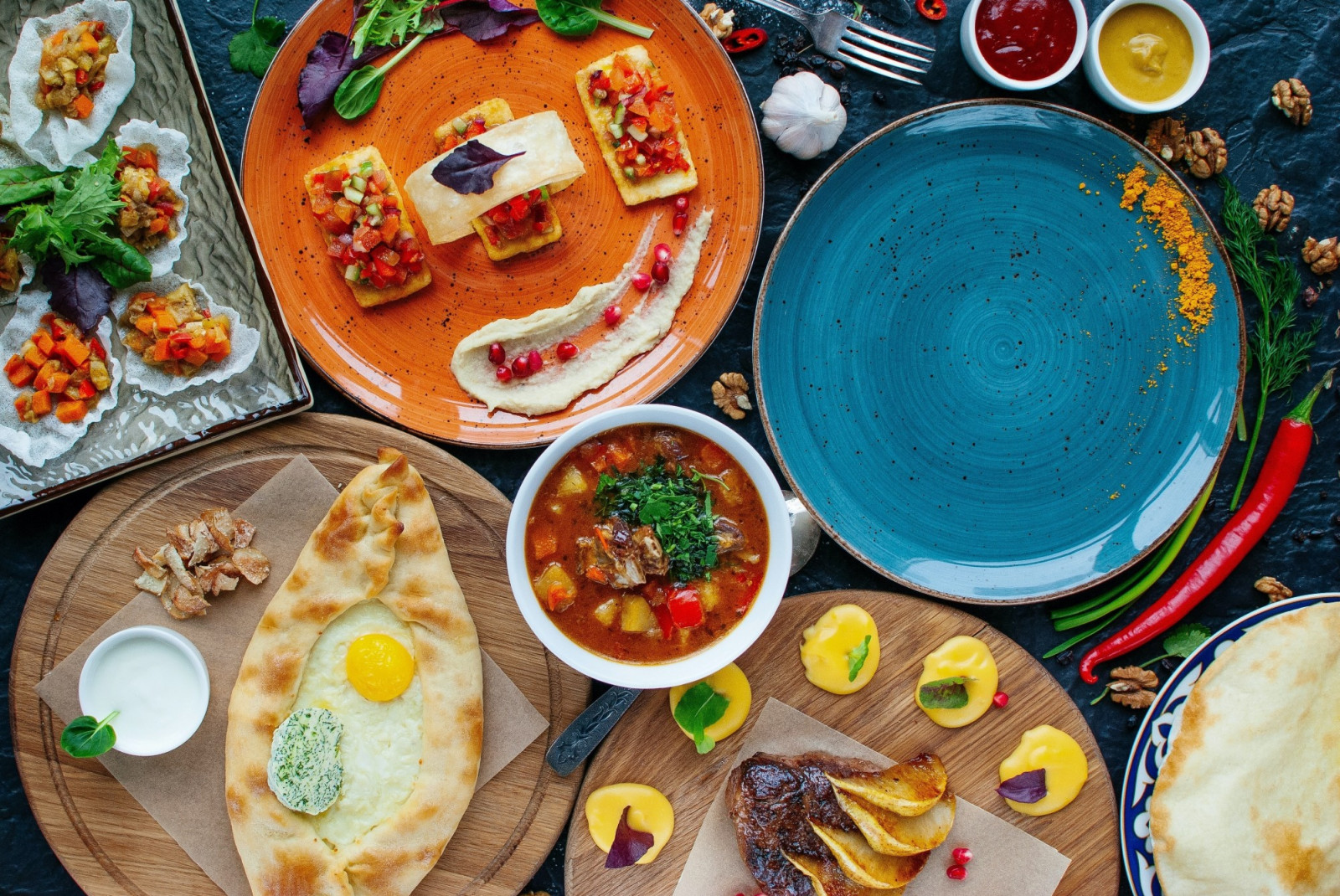 Plate of Lebanese food with pita bread on the side in casual restaurant.