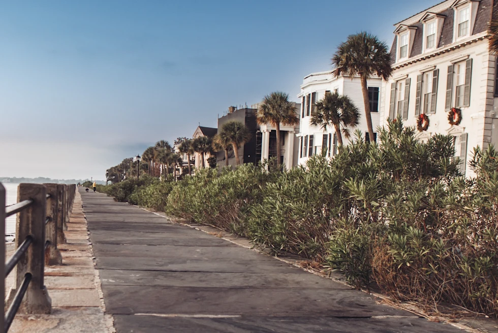 Some house and a street in front of a beach.