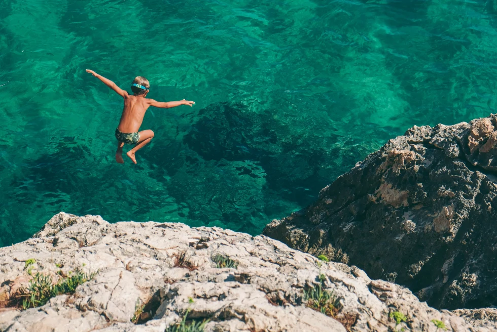 A boy jumping into the sea in Hvar. 