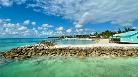 White sand beach with cabanas In Harbor Island, Bahamas.