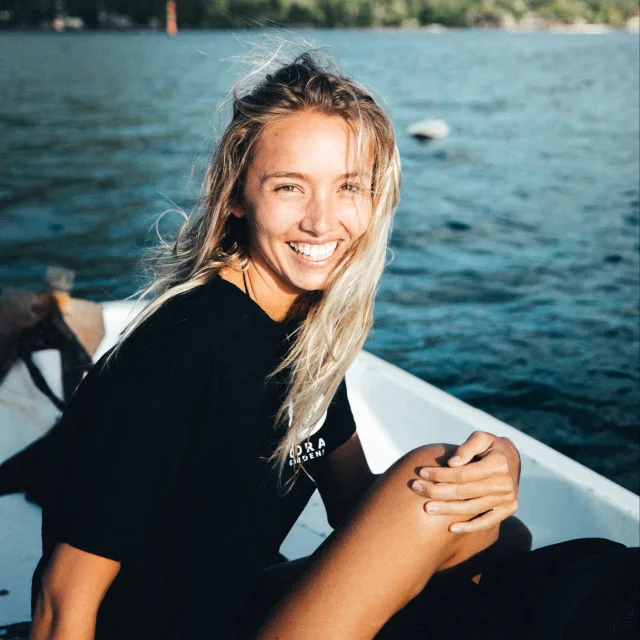 Travel Advisor Racquelle Lawrence with a black shirt on a boat with water in the background.