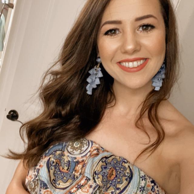 Woman wearing colorful dress smiling at the camera