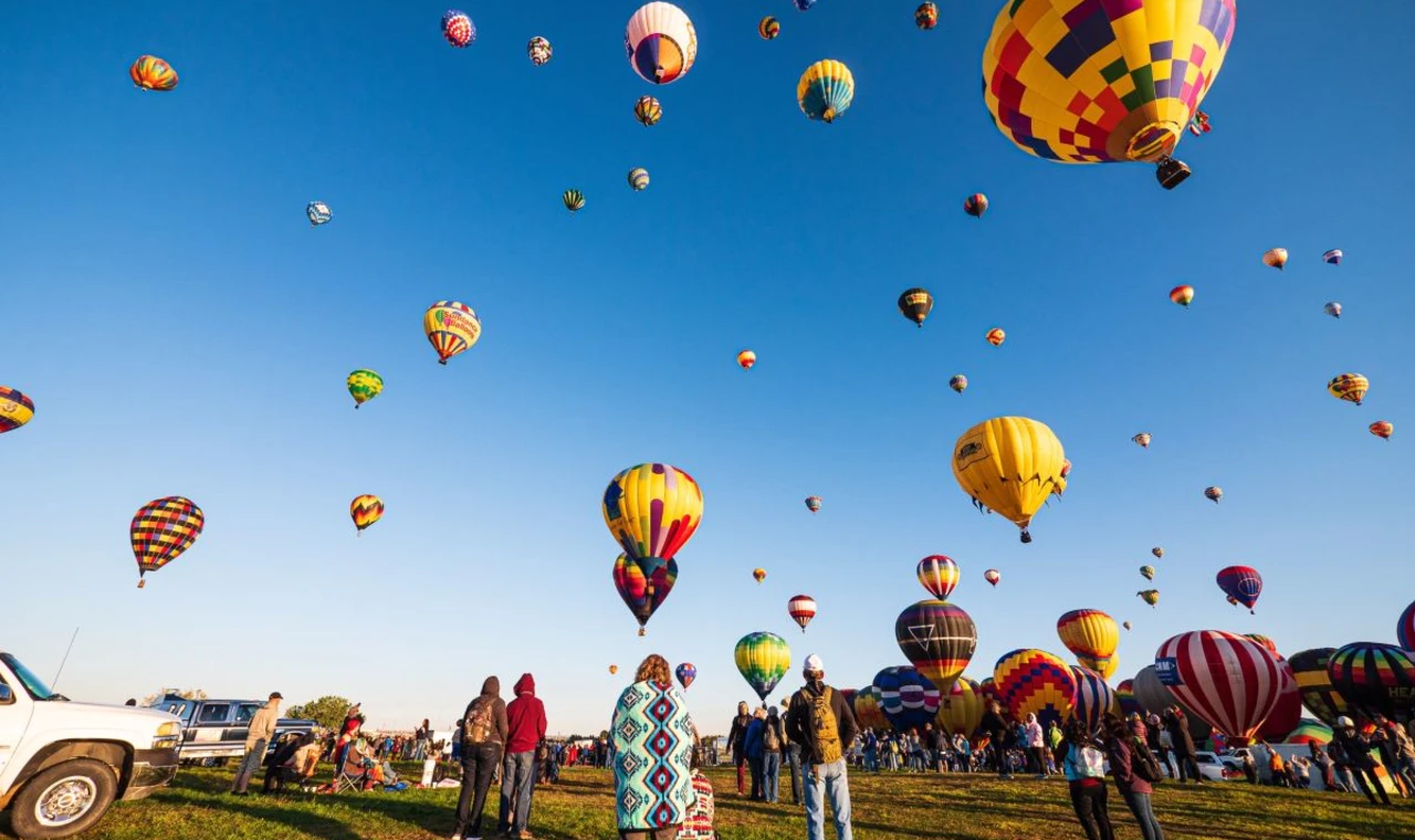 Clear blue sky full of yellow hot air balloons