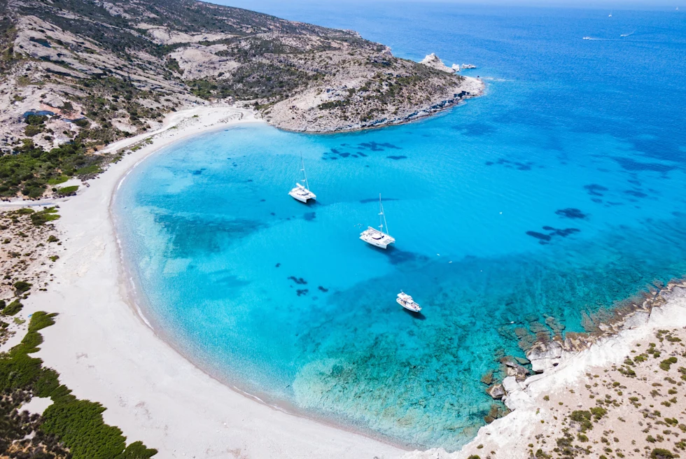 Aerial view of blue body of water next to sandy beach during daytime
