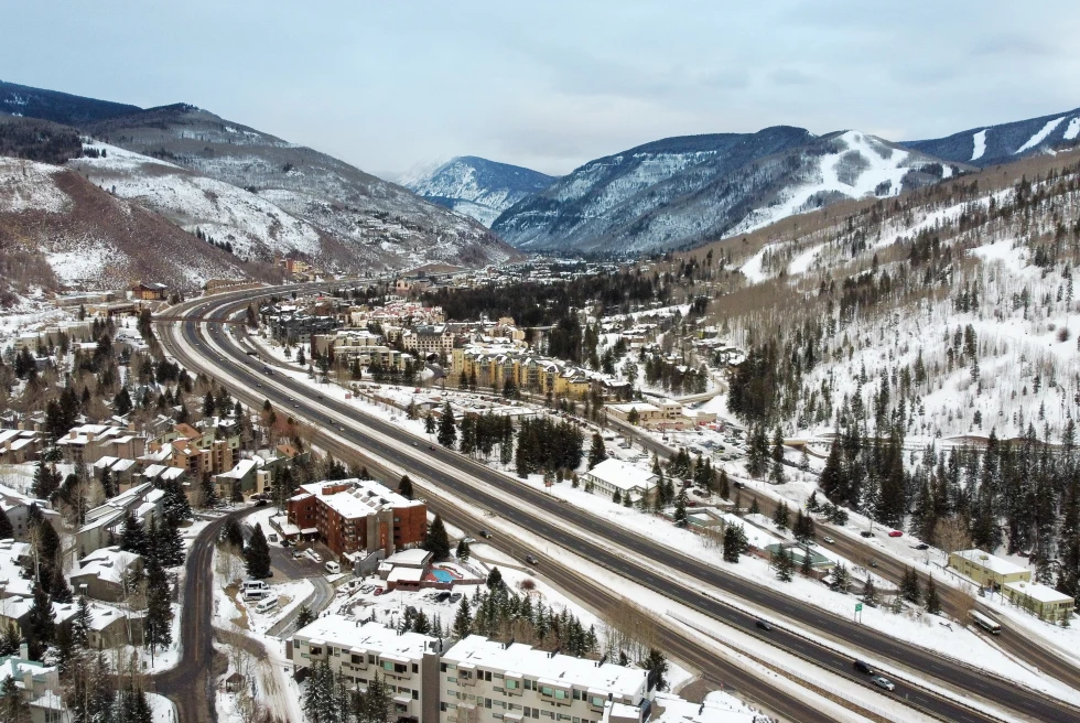 aerial view of roads and village covered in snow