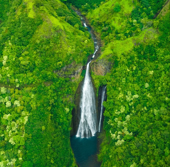 aerial view of waterfall and green mountain