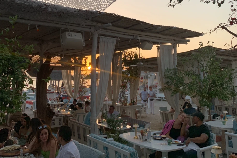 a busy patio of a restaurant at sunset