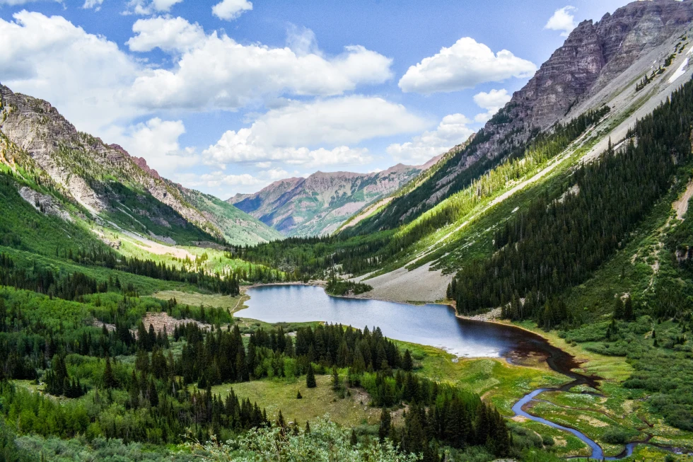 Aspen lake between mountains in the summer.