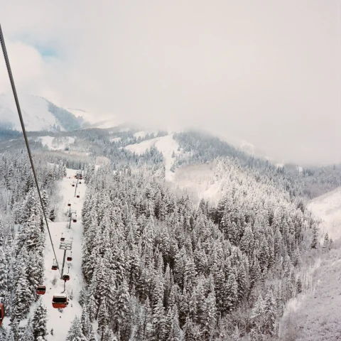 gondolas fly over a ski mountain in winter