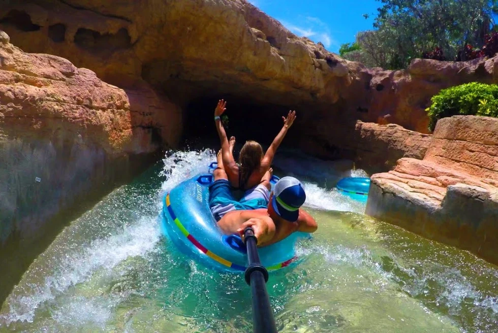 Riding down a water slide. 