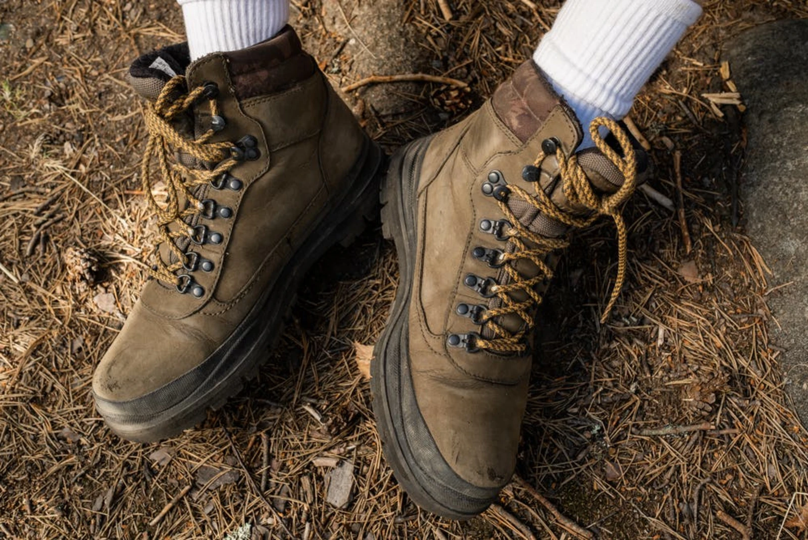 brown hiking boots on dirt with white socks