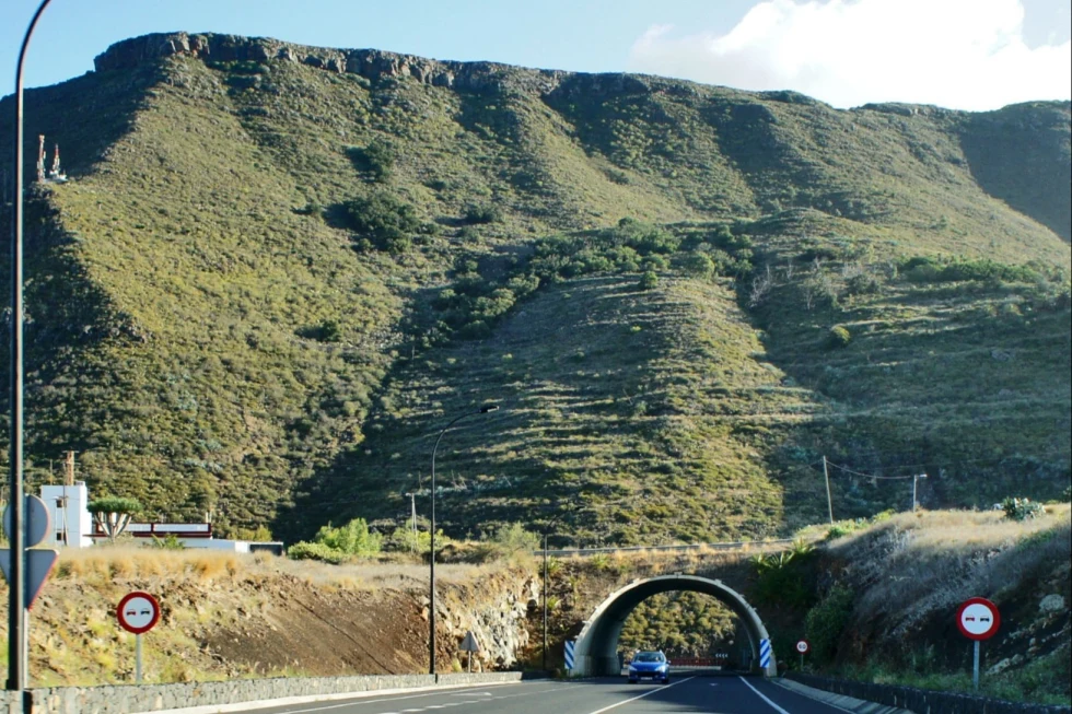 A road with tunnel among the mountains.