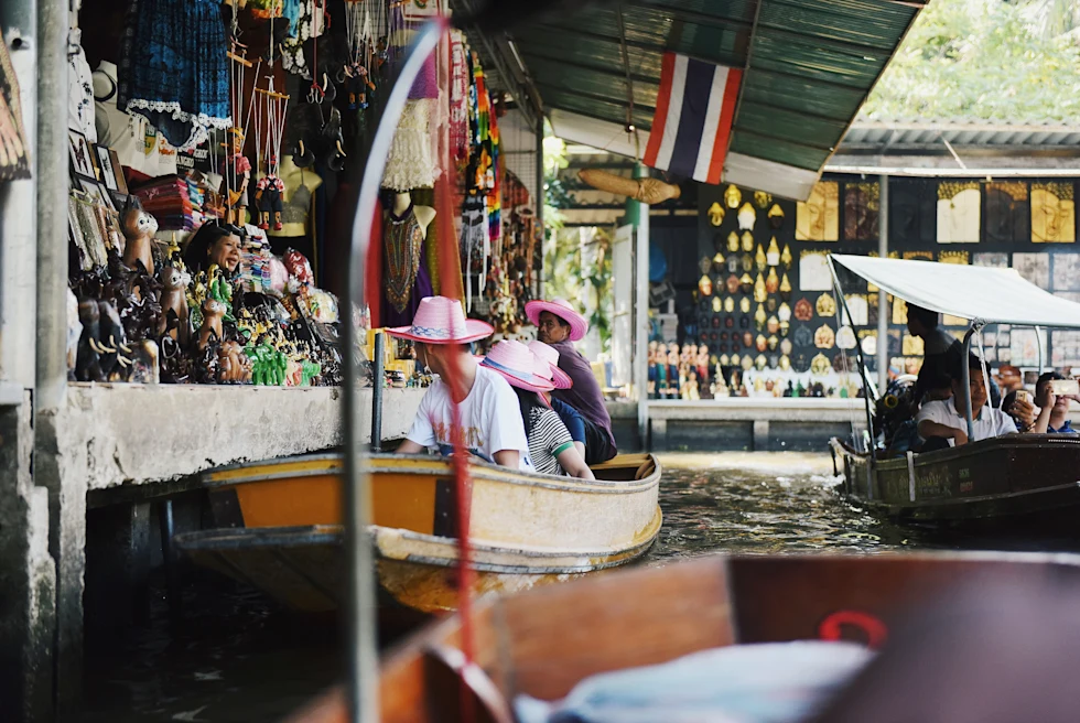 People on boats in a floating market.