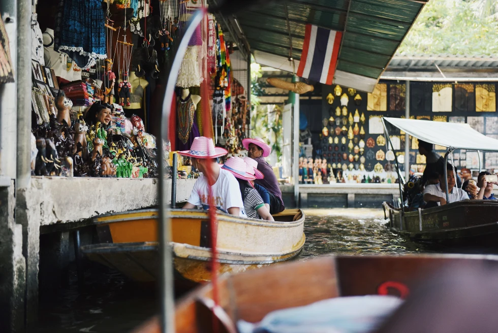People on boats in a floating market. 