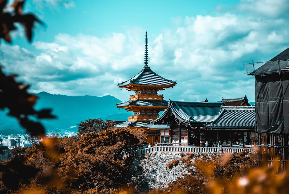 temple with mountains in the background during daytime